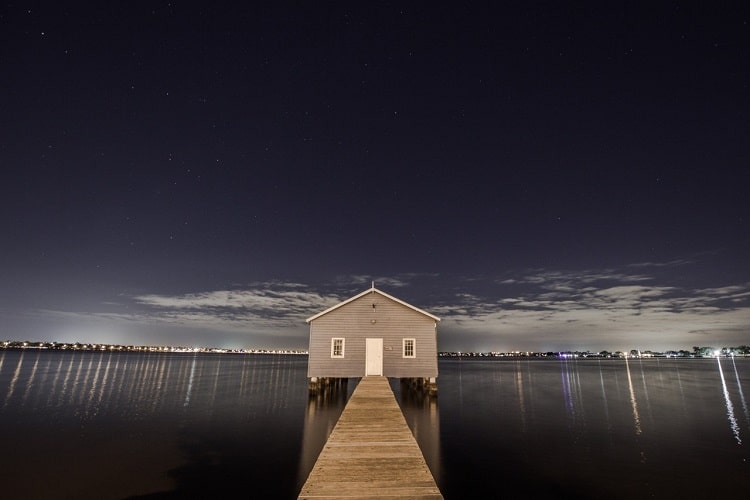 Picture of house on stilts over water with a dock, analogous to using a home equity loan to invest, leverage 