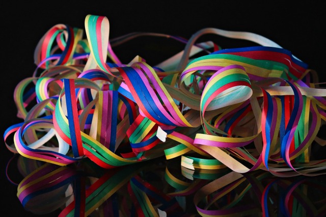 Image of colorful streamers with a black background. List of 7 streams of income beyond a salary. 