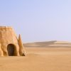 The Definition of Financial Success is Not So Obvious Tataouine scenery on a background of sand dunes.