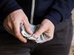 Is Your Salary an Unhealthy Addiction? close up of addict or drug dealer hands with money