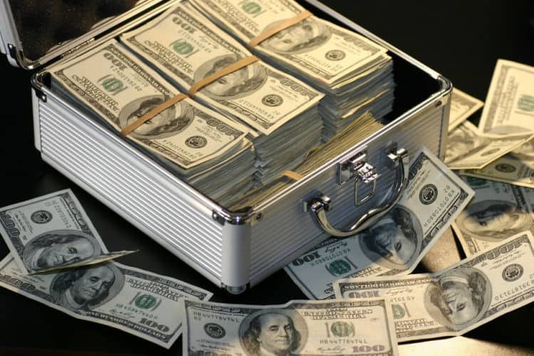 Picture of metal box with $100 bills. How much money is enough to retire or change careers? As my wealth has increased, I've found that net worth is an imperfect measure of enough.