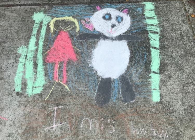 Chalk art of panda, little girl, and bamboo.