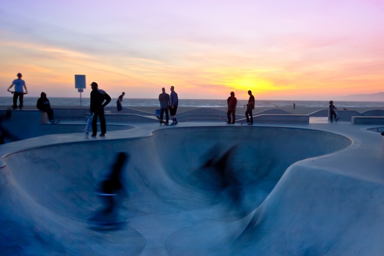 Skateboarder in an empty pool not living a normal, safe life,