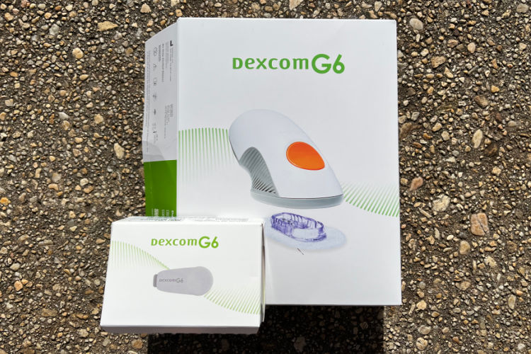 Picture of Dexcom G6 3-pack box and transmitter. 