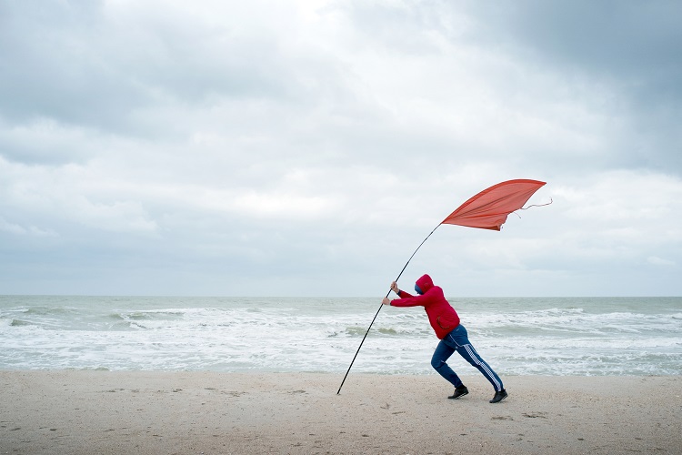 Man carrying flag against the wind. It's not easy to change careers, it takes planning and some unconventional thinking.