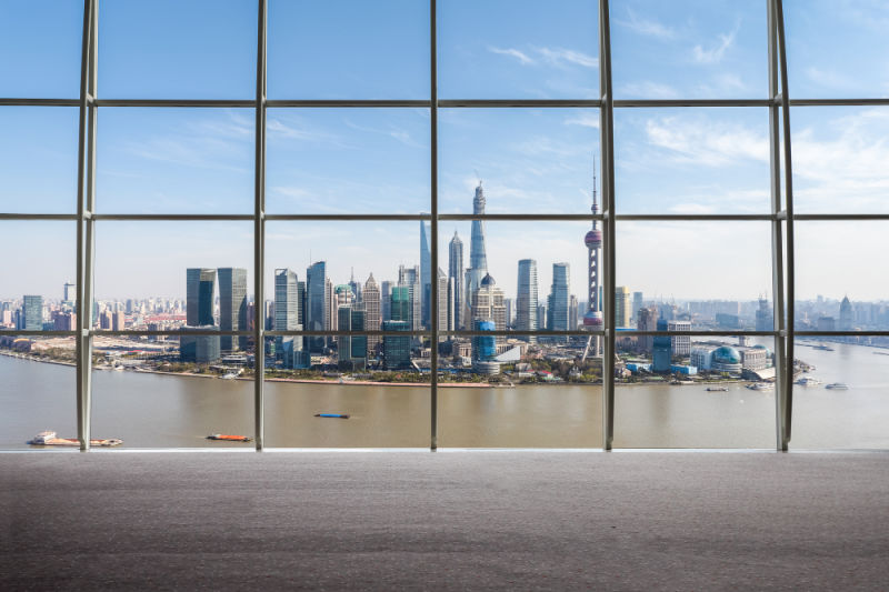 Learn to invest outside the stock market. Photograph looking outside a window to Shanghai. 