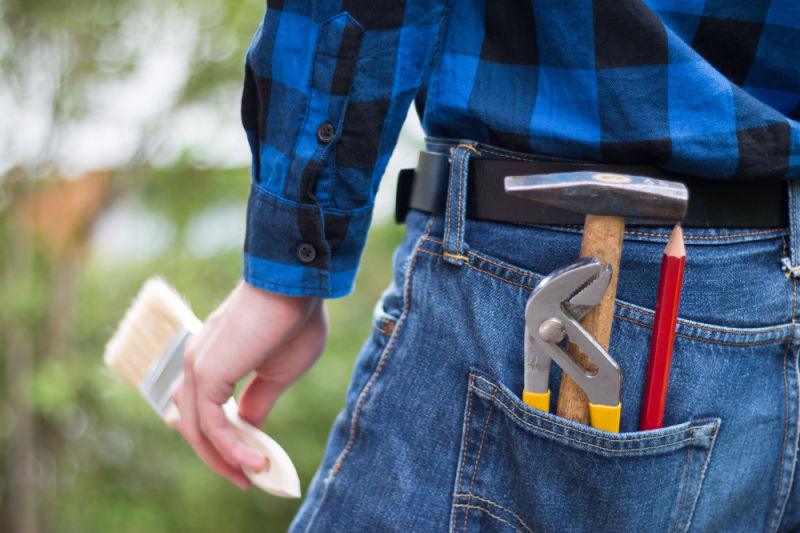 Handyman with tools in his back pocket. Investors can use these retirement income investment tools to create a post-career paycheck. 